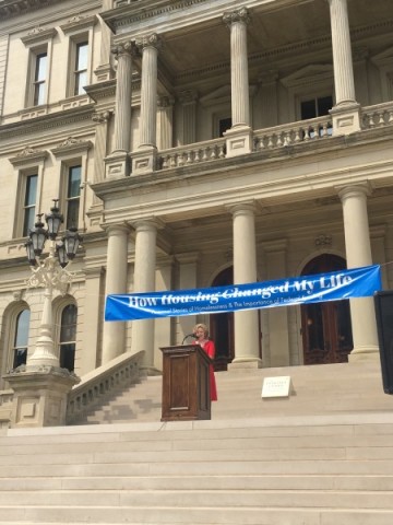 Habitat for Humanity Michigan Executive Director Sandy Pearson opens the How Housing Changed My Life rally & storytelling event on July 26, 2017